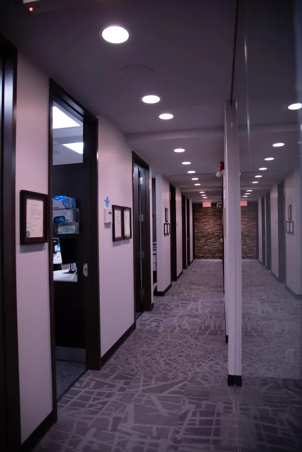 A hallway at Glenbrook Dental with several doors along the left side