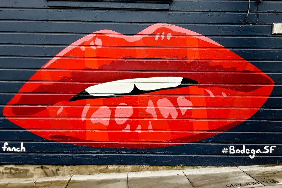 Red colored painted lips on a wall