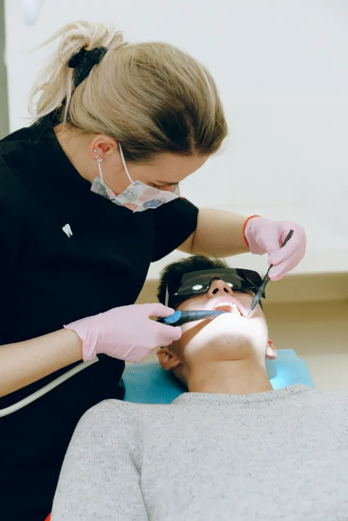 A patient lying while a dentist is performing a procedure on him